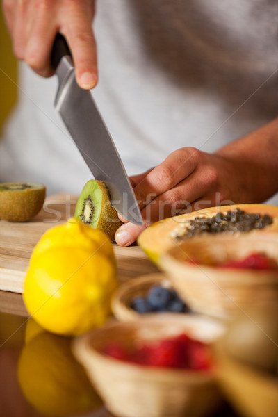 Mid-section of male staff cutting kiwifruit at organic section Stock photo © wavebreak_media