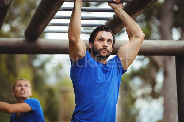 Fit man climbing monkey bars Stock photo © wavebreak_media