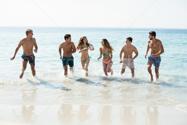 Amis courir rive plage ciel homme [[stock_photo]] © wavebreak_media