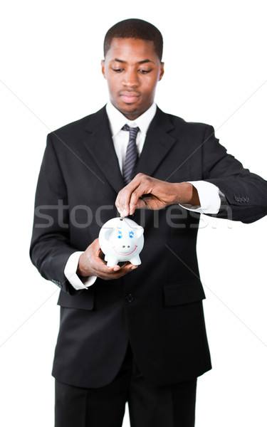 Portrait of a Businessman putting money in his piggy bank  Stock photo © wavebreak_media