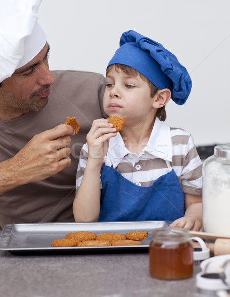 Father and son eating cookies Stock photo © wavebreak_media