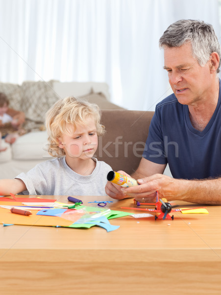 Little boy drawing with his grand father at home Stock photo © wavebreak_media