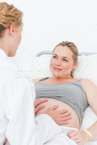 Nurse reassuring her pregnant patient Stock photo © wavebreak_media