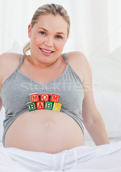 Pregnant woman with baby cubes on her belly Stock photo © wavebreak_media