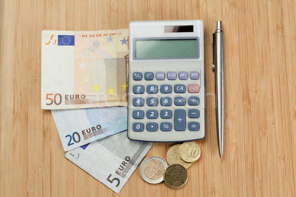 Money with pen and pocket calculator on a desk Stock photo © wavebreak_media