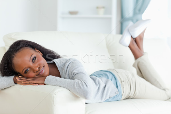 Stock photo: Smiling woman taking a moment off on couch