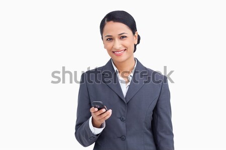 Close up of smiling saleswoman holding cellphone against a white background Stock photo © wavebreak_media