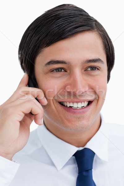 Stock photo: Close up of smiling tradesman on his cellphone against a white background