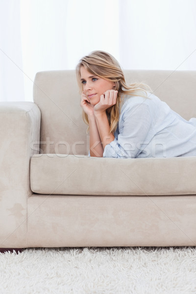 A young woman resting her head on her hands is thinking Stock photo © wavebreak_media