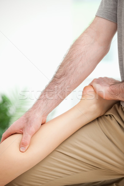 Physiotherapist massaging the leg of a woman in a room Stock photo © wavebreak_media