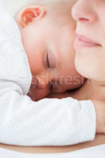 Baby napping on the chest of her mother indoors Stock photo © wavebreak_media