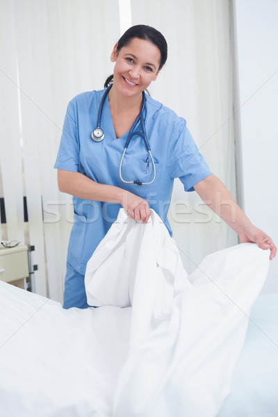 Nurse changing sheets on the bed in hospital ward Stock photo © wavebreak_media