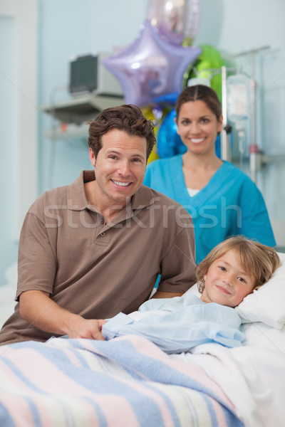 Child and his father looking at camera in hospital ward Stock photo © wavebreak_media