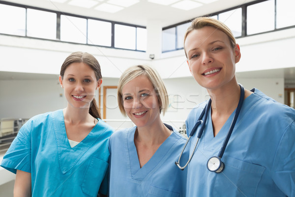 Three happy nurses at hospital stairwell Stock photo © wavebreak_media