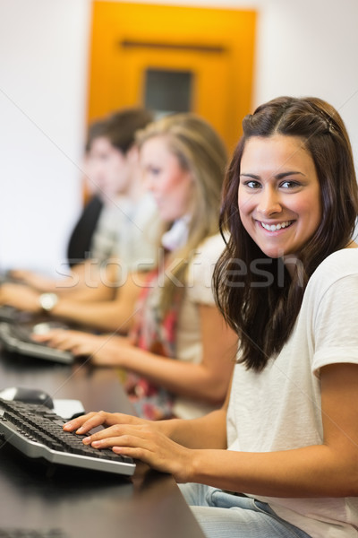 Studente seduta computer sorridere college sala computer Foto d'archivio © wavebreak_media