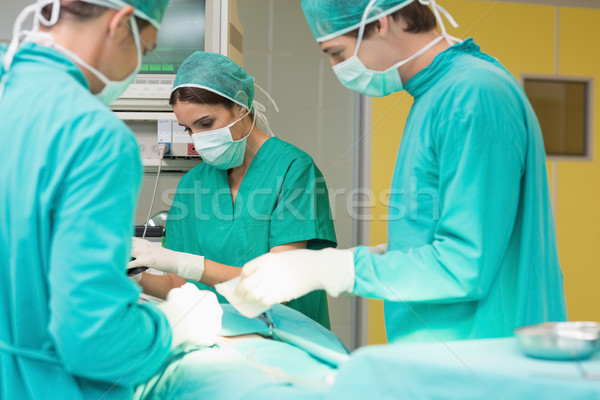 Surgeons working on a patient with his teams Stock photo © wavebreak_media