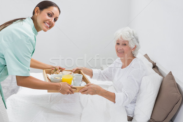 Home nurse giving a breakfast to the old woman Stock photo © wavebreak_media