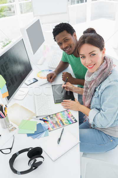 Artist with colleague drawing something on graphic tablet Stock photo © wavebreak_media