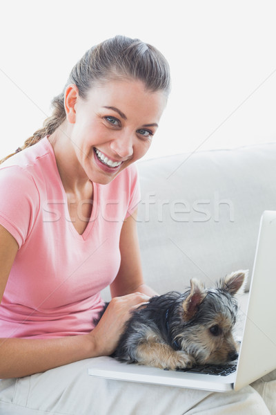 Mosolygó nő laptopot használ Yorkshire terrier otthon nappali Stock fotó © wavebreak_media