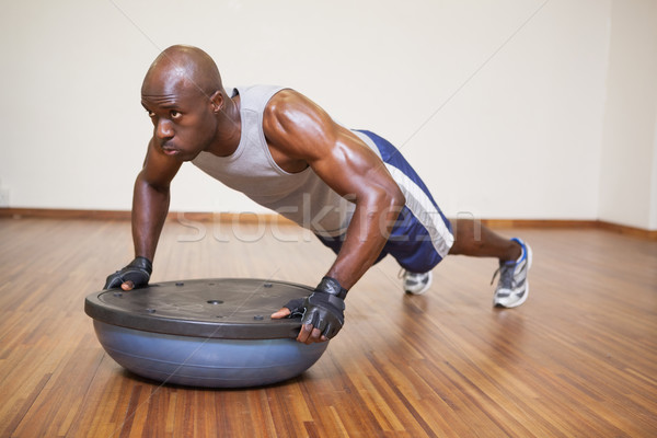 Muscular man doing push ups in gym Stock photo © wavebreak_media
