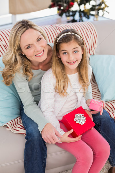 Daughter opening christmas gift with mother Stock photo © wavebreak_media