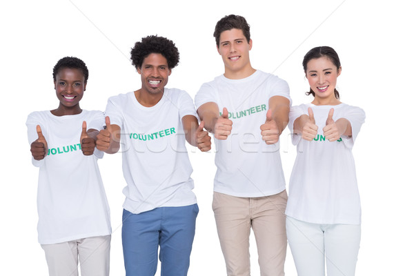 Zdjęcia stock: Młodych · uśmiechnięty · wolontariusze · patrząc · kamery · biały
