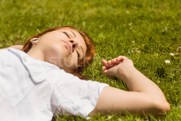 Pretty redhead napping on grass Stock photo © wavebreak_media