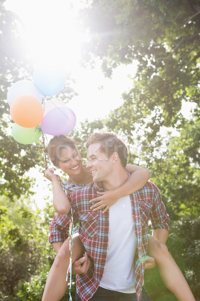 Cute couple having fun with balloons Stock photo © wavebreak_media