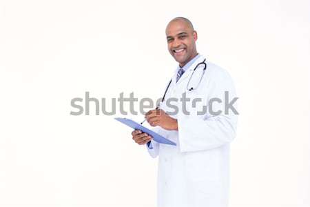 Lekarza biały tunika piśmie zauważa notebooka Zdjęcia stock © wavebreak_media