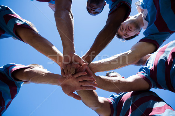 Low angle view of rugby team holding hands Stock photo © wavebreak_media