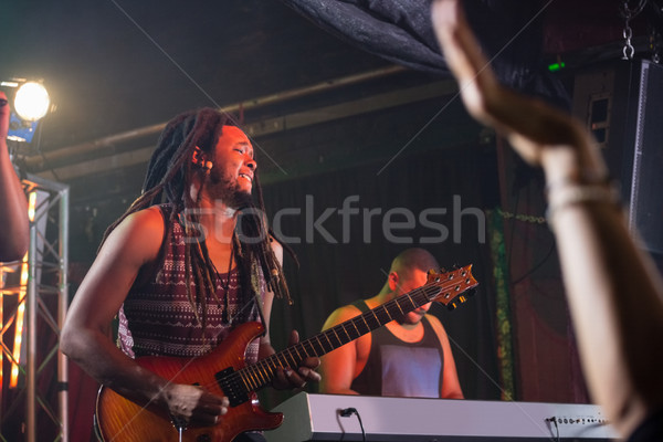 Stock photo: Guitarist playing guitar on stage