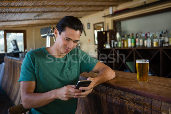 Man using phone while sitting at bar counter Stock photo © wavebreak_media