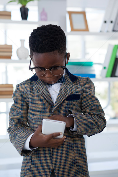 Businessman wearing eyeglasses using smart phone Stock photo © wavebreak_media