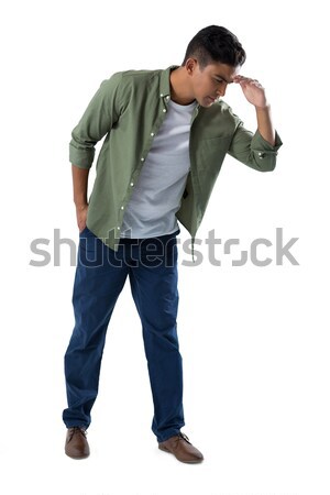 Man shielding eyes on white background Stock photo © wavebreak_media