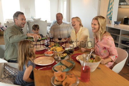 Group of happy friends applauding woman while dining Stock photo © wavebreak_media