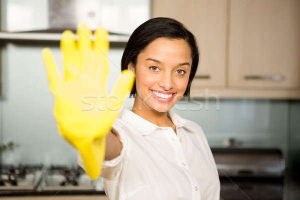 улыбаясь брюнетка желтый перчатка Сток-фото © wavebreak_media