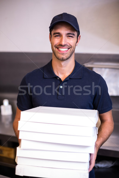 Pizza delivery man carrying boxes Stock photo © wavebreak_media