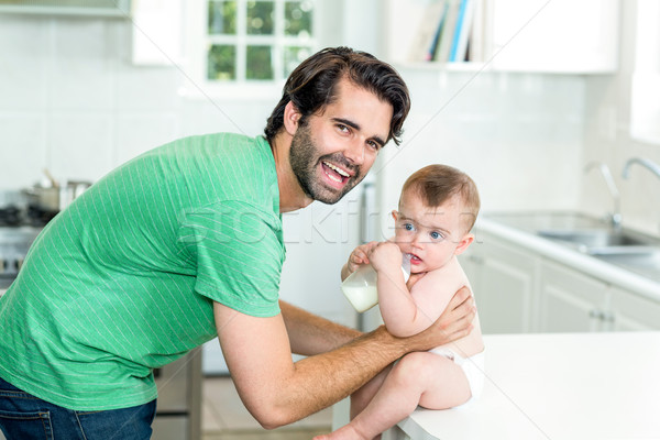 Heureux père en fils potable lait table de cuisine portrait [[stock_photo]] © wavebreak_media