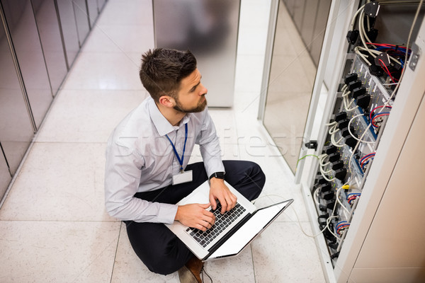 Technician using laptop while analyzing server Stock photo © wavebreak_media