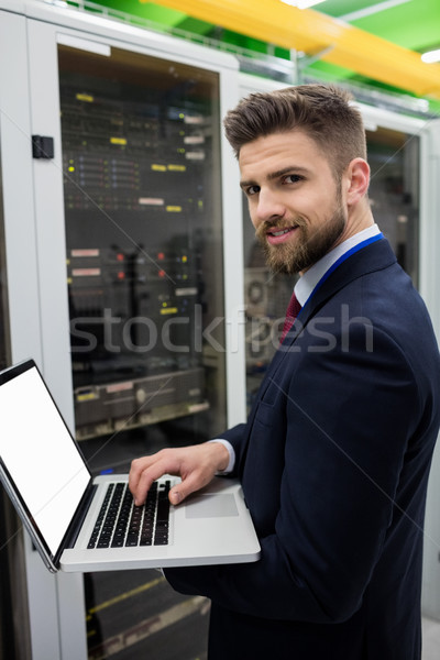 Technician using laptop while analyzing server Stock photo © wavebreak_media