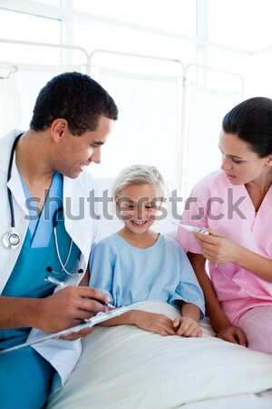 Doctor showing x-ray report to patient and his parent Stock photo © wavebreak_media