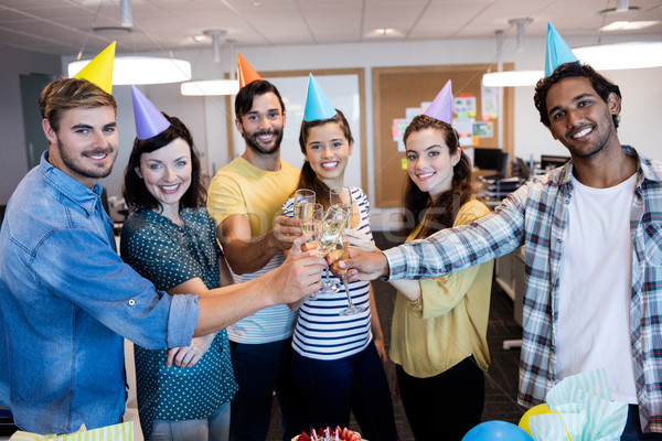 Creative business team having a toast on colleges birthday Stock photo © wavebreak_media