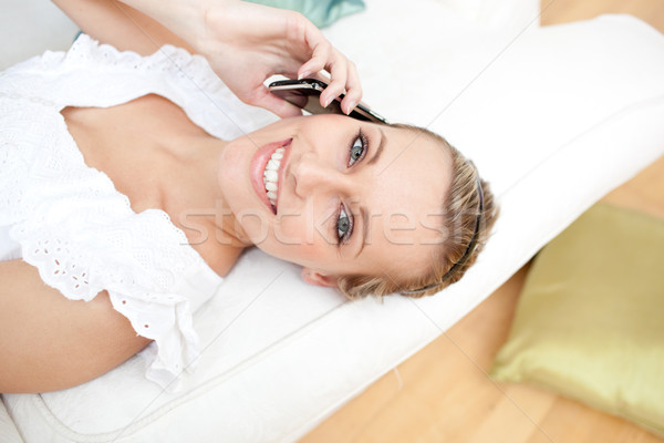 Jolly woman talking on phone lying on a sofa Stock photo © wavebreak_media