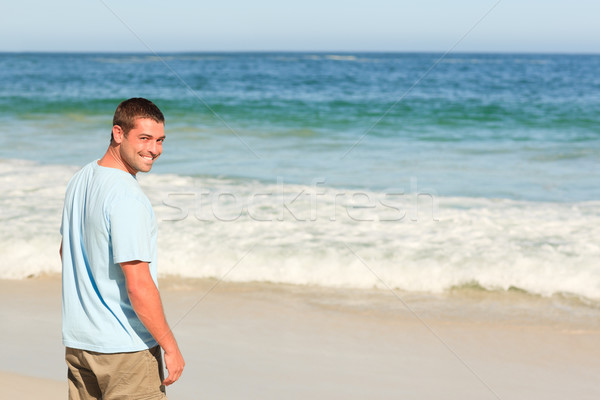 Handsome man walking on the beach Stock photo © wavebreak_media