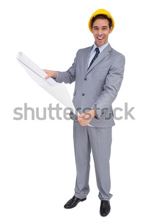 Smiling businesswoman holding clipboard against a white background Stock photo © wavebreak_media