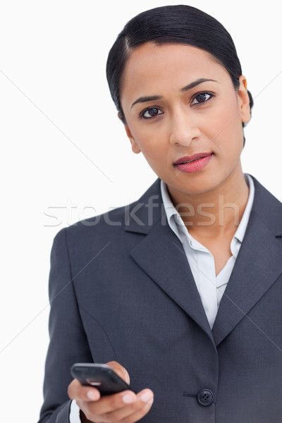 Close up of saleswoman holding cellphone against a white background Stock photo © wavebreak_media