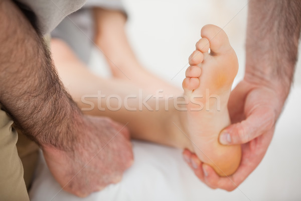 Barefoot being touched by a physiotherapist indoors Stock photo © wavebreak_media
