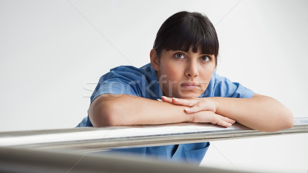 Nurse leaning against rail and thinking in hospital corridor Stock photo © wavebreak_media