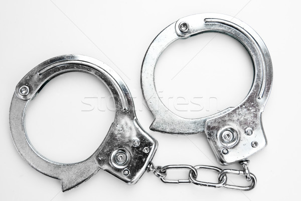 Stock photo: Silver handcuffs against white background