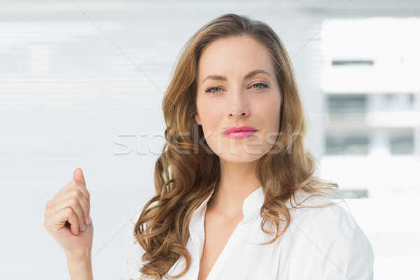 Stock photo: Smiling young businesswoman against blinds